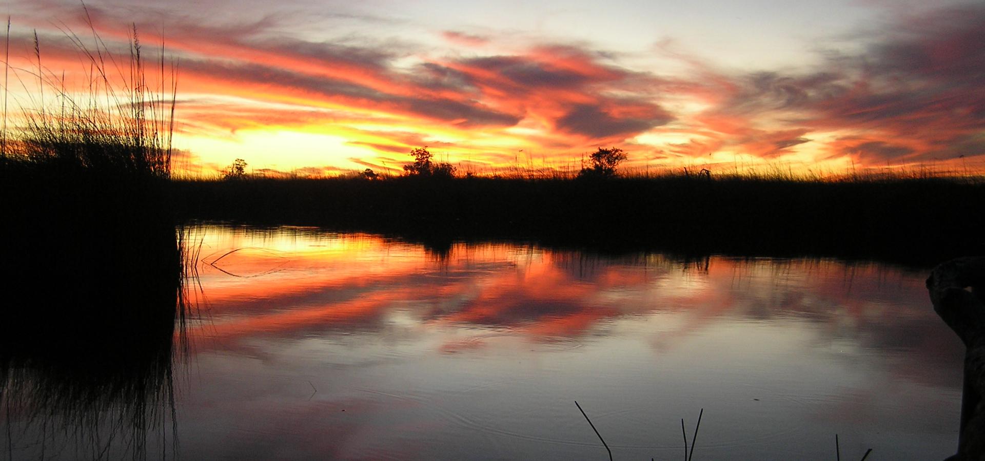 Erleben Sie atemberaubende Sonnenuntergänge im Okavango Delta in Botswana